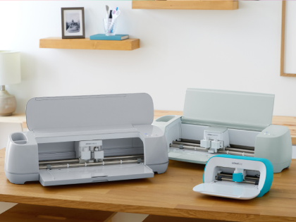 Cricut Maker 3, Cricut Explore 3, and Cricut Joy cutting machines sitting on a table