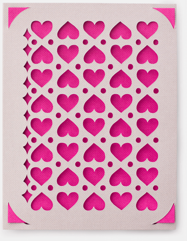 A pink and white card with a heart, circle, and star pattern on it.